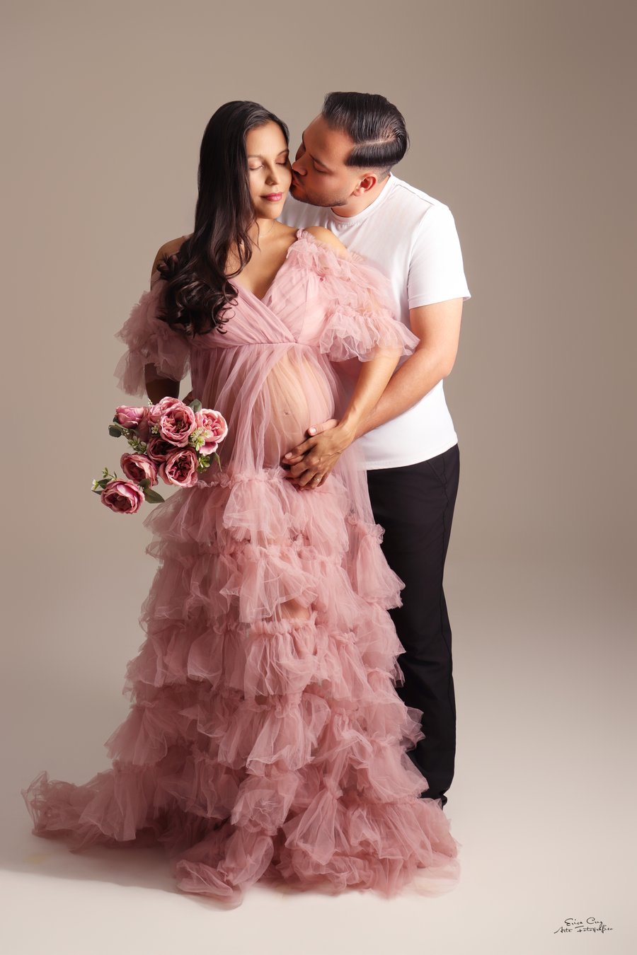 Pareja esperando a su bebé, ella con vestido rosa de tul y ramo de flores, Erica Cruz
